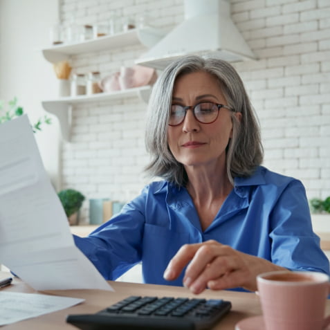 An older woman reviewing some documents