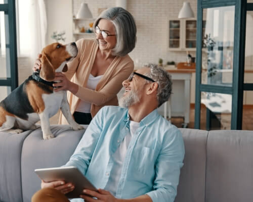 An older couple smiling at home